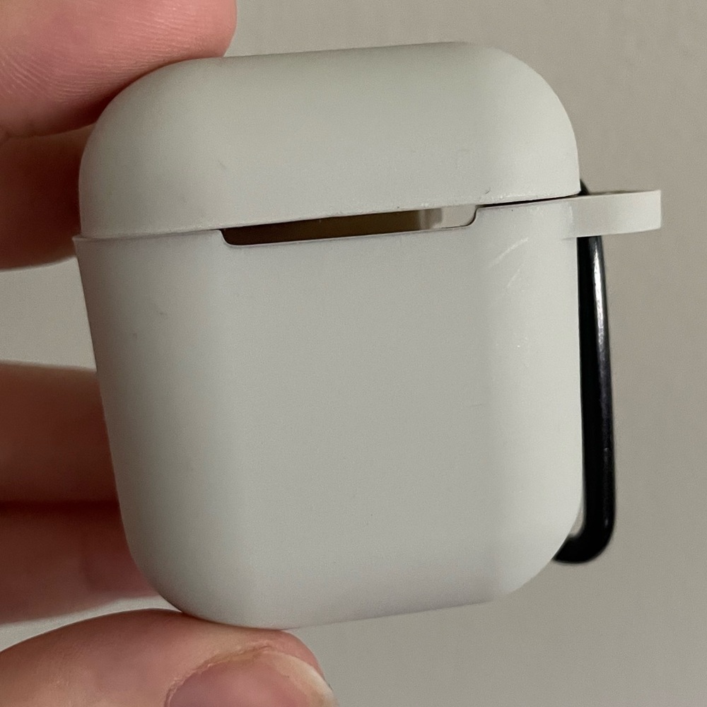 Gray silicone AirPods case with black caribeaner